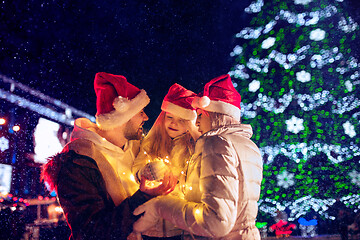 Image showing family, christmas, holidays, season and people concept - happy family over city background and snow