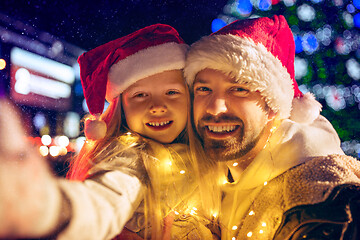 Image showing family, christmas, holidays, season and people concept - happy family over city background and snow