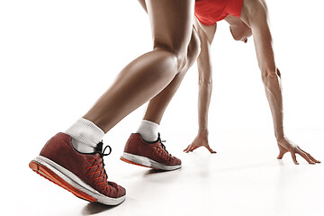 Image showing Portrait of young sporty woman at starting block of race isolated over white background