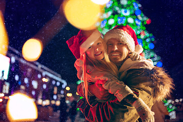 Image showing family, christmas, holidays, season and people concept - happy family over city background and snow