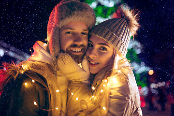 Image showing Adult couple hanging out in the city during Christmas time