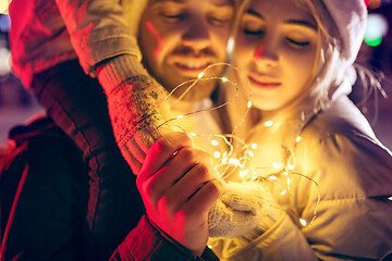 Image showing Adult couple hanging out in the city during Christmas time