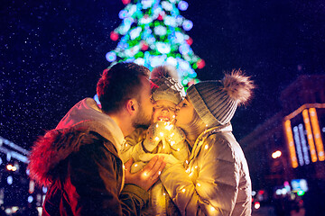 Image showing family, christmas, holidays, season and people concept - happy family over city background and snow