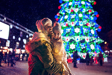 Image showing Adult couple hanging out in the city during Christmas time