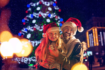 Image showing family, christmas, holidays, season and people concept - happy family over city background and snow