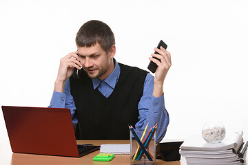 Image showing dispatcher solves problems by talking on two phones