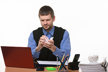 Image showing man in the office clumps a piece of paper on a white background