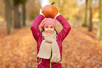 Image showing happy girl with pumpkin at autumn park