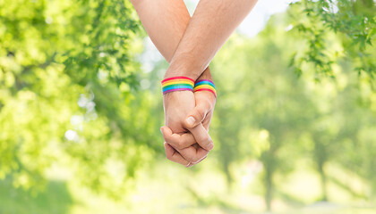 Image showing hands of couple with gay pride rainbow wristbands