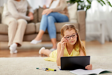 Image showing student girl with tablet pc lying on floor at home