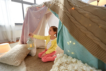 Image showing little girl with lantern in kids tent at home