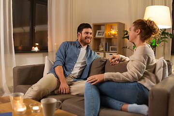 Image showing happy couple talking at home in evening