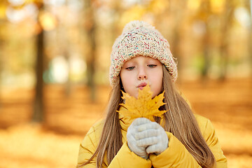 Image showing portrait of girl with maple leaf at autumn park