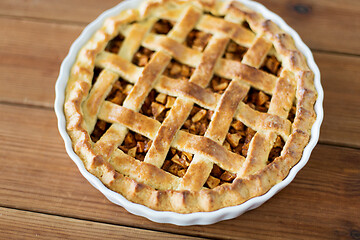 Image showing close up of apple pie in mold on wooden table