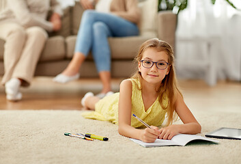 Image showing student girl writing to notebook at home