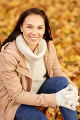 Image showing beautiful happy young woman smiling in autumn park