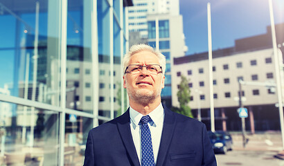 Image showing senior businessman on city street