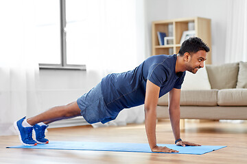 Image showing indian man doing push ups at home