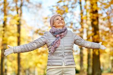 Image showing happy senior woman enjoying beautiful autumn