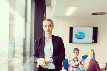 Image showing portrait of young business woman at office with team on meeting 