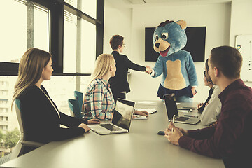 Image showing boss dresed as bear having fun with business people in trendy of