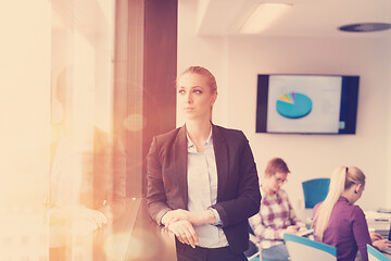 Image showing portrait of young business woman at office with team on meeting 