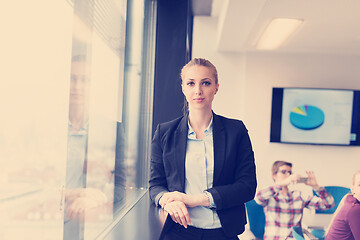 Image showing portrait of young business woman at office with team on meeting 