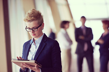 Image showing business woman  at office with tablet  in front  as team leader