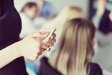 Image showing Elegant Woman Using Mobile Phone in office building