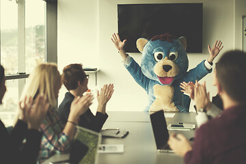 Image showing boss dresed as bear having fun with business people in trendy of