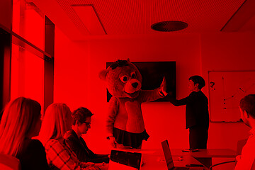 Image showing boss dresed as bear having fun with business people in trendy of