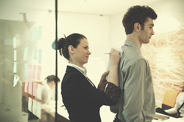 Image showing young couple signing contract documents on partners back