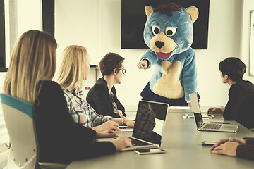 Image showing boss dresed as bear having fun with business people in trendy of