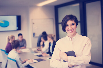 Image showing hispanic businesswoman with tablet at meeting room