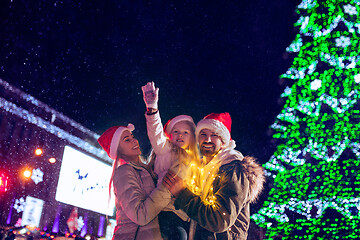 Image showing family, christmas, holidays, season and people concept - happy family over city background and snow