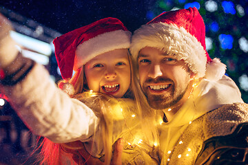 Image showing family, christmas, holidays, season and people concept - happy family over city background and snow