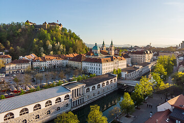 Image showing Aerial drone panoramic view of Ljubljana medieval city center, capital of Slovenia in warm afternoon sun. Empty streets during corona virus pandemic social distancing measures