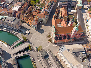 Image showing Aerial drone view of Preseren Squere and Triple Bridge over Ljubljanica river,Tromostovje, Ljubljana, Slovenia. Empty streets during corona virus pandemic social distancing measures