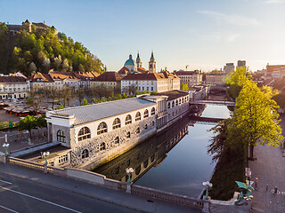 Image showing Aerial drone panoramic view of Ljubljana medieval city center, capital of Slovenia in warm afternoon sun. Empty streets during corona virus pandemic social distancing measures