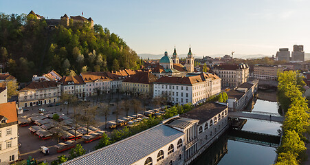 Image showing Aerial drone panoramic view of Ljubljana medieval city center, capital of Slovenia in warm afternoon sun. Empty streets during corona virus pandemic social distancing measures