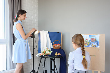 Image showing An art school teacher explains to a student how to draw a still life