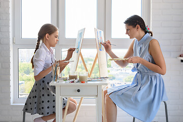 Image showing Girl and tutor conduct a joint drawing lesson