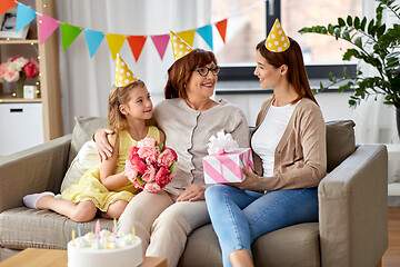 Image showing mother with gift greeting grandmother on birthday