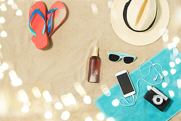 Image showing smartphone, hat, flip flops and shades on beach