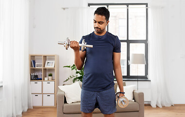 Image showing indian man exercising with dumbbells at home