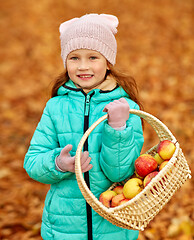 Image showing girl with apples in wicker basket at autumn park