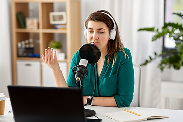 Image showing woman with microphone recording podcast at studio