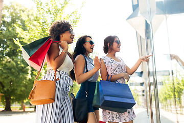 Image showing women with shopping bags looking at shop window