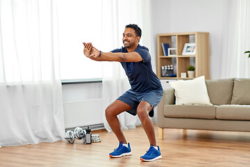 Image showing indian man exercising and doing squats at home