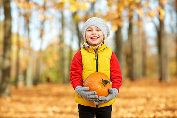 Image showing happy little boy with pumpkin at autumn park